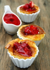 Cheese souffle with cherry sauce.