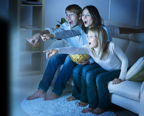 Family watching TV. True Emotions