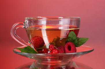 green tea in transparent cup with mint and berry