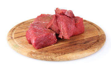 raw meat on wooden board isolated on white