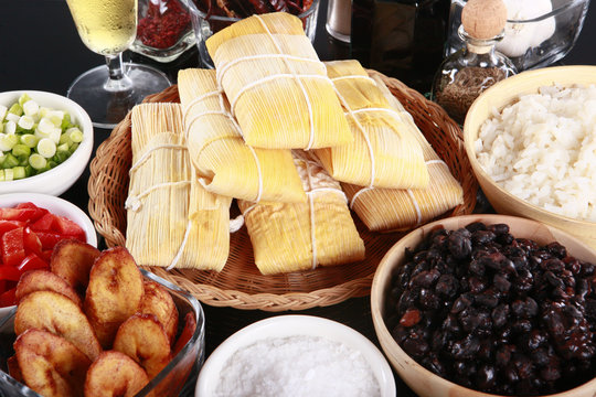 Staple latino sides, tamale, rice, plantains, and black beans