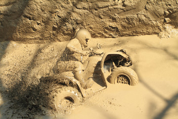 man badly stuck in mud with his quadbike