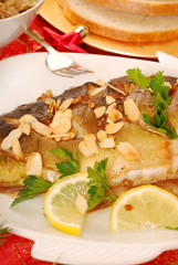 carp baked with almonds on christmas table