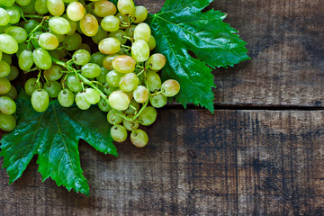 Green grapes on a rustic wooden table - 35851396
