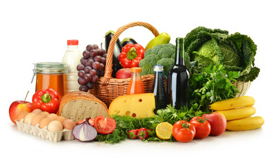 Groceries in wicker basket including vegetables and fruits