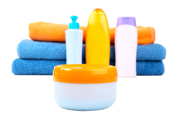 Terry towels and tubes with cosmetics isolated