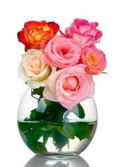 Beautiful bouquet of roses in transparent vase isolated on white