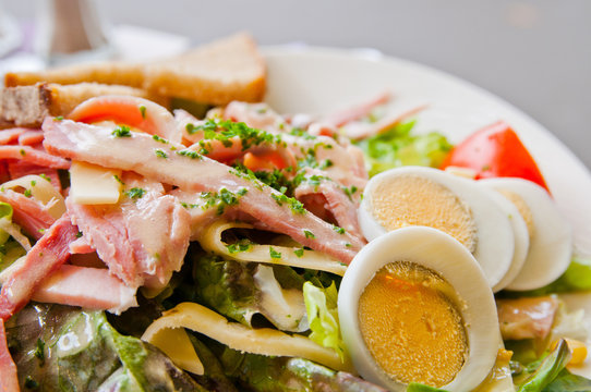 Fresh fruits salad and ham with egg