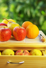 Fruits and knife on table.