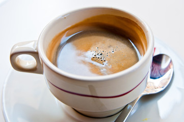 wonderful white cup of hot coffee on table