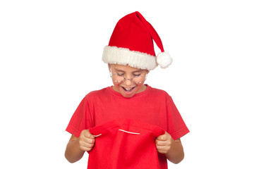 Surprise child with Santa Hat looking in sack