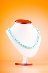 Stand with necklace in fashion concept