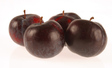 4 Plums on white background.