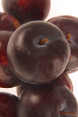 Plums on white background.