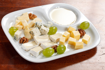 Cheese plate with grapes and honey
