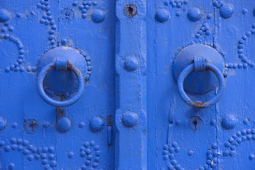 Oriental beautiful blue knocker and traditional door in Tunisia
