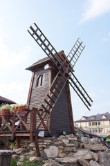 Fototapeta na wymiar Decorative windmill - wood sculpture