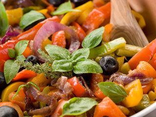 peperonata with basil and black olives close up