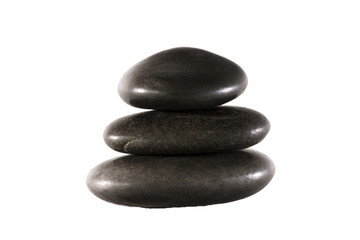 Fototapeta na wymiar three black stones balanced on white background