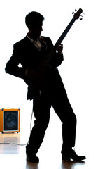 Bass player in a suit and electric amp