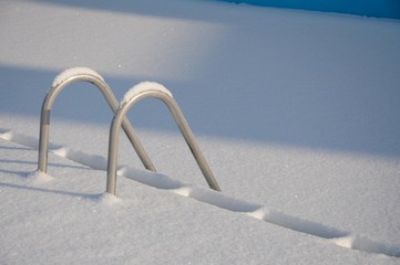 Snowy swimming pool stairs
