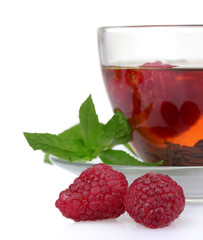 black tea, mint and raspberry in cup isolated on white