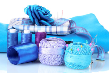 bright blue yarn, fabric, satin ribbon and measuring tape