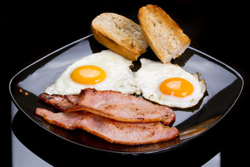 Irish breakfast with two eggs, bacon and toast