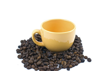 cup in a pile of coffee beans