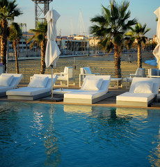 zone of rest with pool on quay of mediterranean sea in barcelona