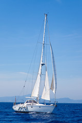 Blue Mediterranean sailboat sailing