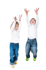 two excited kids jumping up isolated on white background