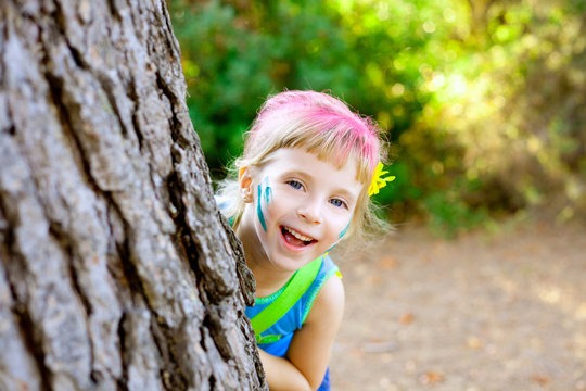 children little girl happy playing in forest tree