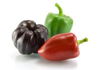 Red, green and violet sweet pepper on a white background