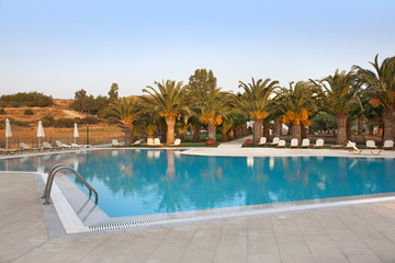 Empty swimmingpool with palmtrees