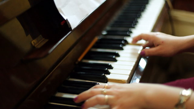 Womens hands play the piano