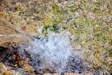 falling water in little waterfall in water spring