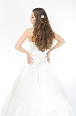 Long curly hair. Bride with hairstyle in wedding dress. Back vie