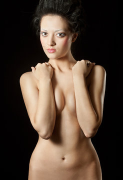 naked slim woman with perfect body over black background