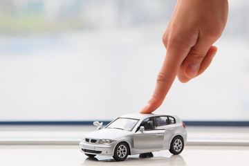 The finger moves the toy car