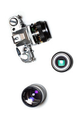 Analog film SLR camera and two lenses isolated on white