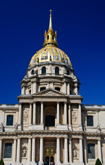 Fototapeta na wymiar Invalides palace in Paris showing golden dome in blue sky