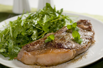 Plate of steak and green salad