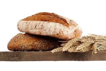 Bread loaf and buns on a shelf