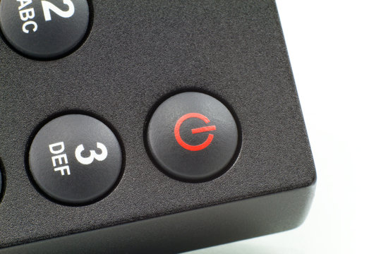 Close-up detail of a remote control on/off button