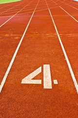 Number four on the start of a running track