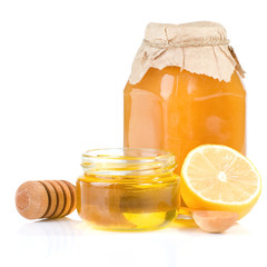 jar full of honey and lemon on white