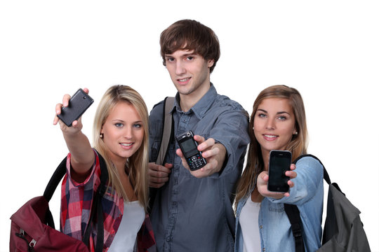 Teenagers showing mobile phones