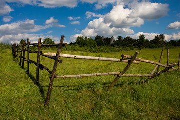 Fototapeta na wymiar Meadow and wooden fence