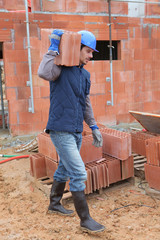 mason carrying a brick